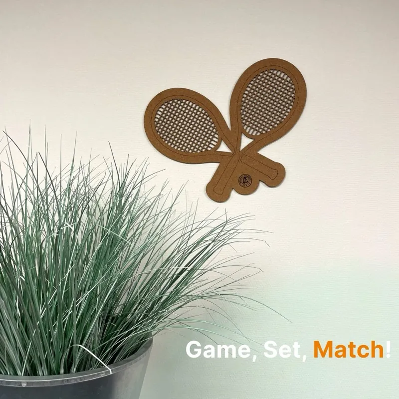 Crossed tennis rackets in cork, made with a CO₂ laser