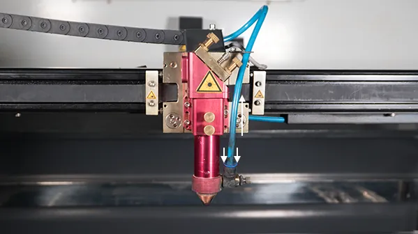 Disconnecting the air hose from the connector on the laser head