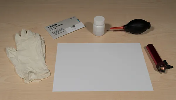 Lens cleaning materials: gloves, lens cleaning paper, alcohol, air blower and the lens shaft