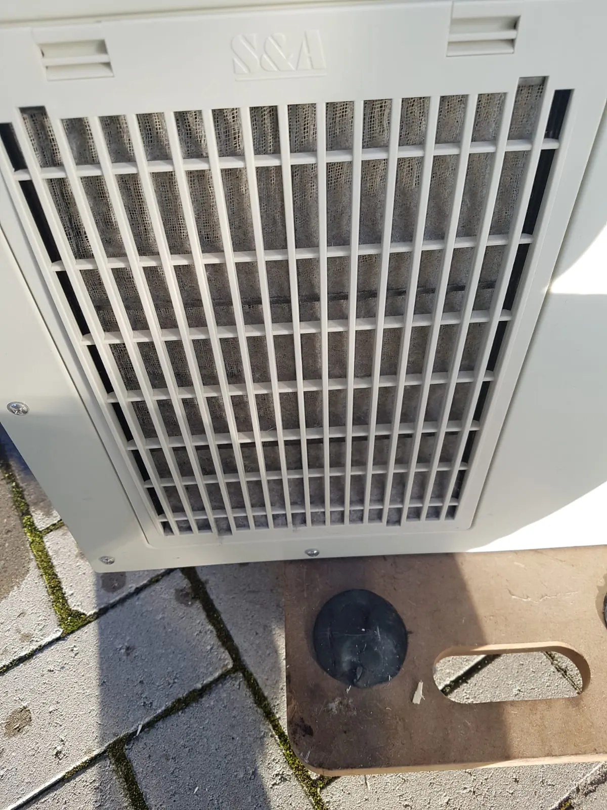 Dust-clogged air filter on the side of a CW-5000 water chiller